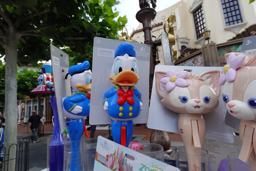Donald duck and linabell character merchandise displayed in a park.
